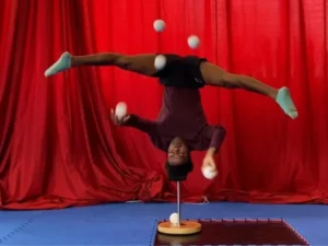 World Record for Juggling Five Balls While Standing on Head