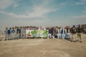 Participants plant saplings during the Margalla Hills plantation campaign launched in Islamabad.