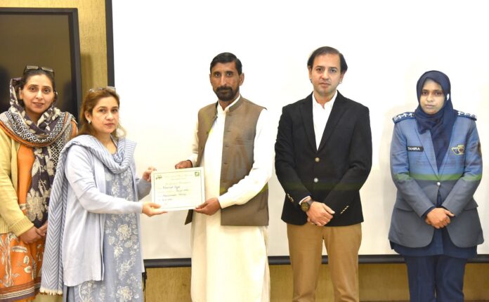 Participants attend transport safety workshop at Fatima Jinnah Women University in Rawalpindi.