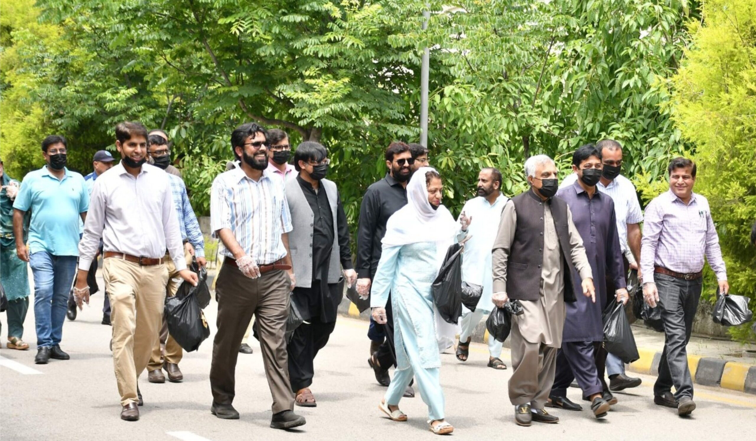 Students and faculty participate in the cleanliness awareness campaign at Arid University Rawalpindi.