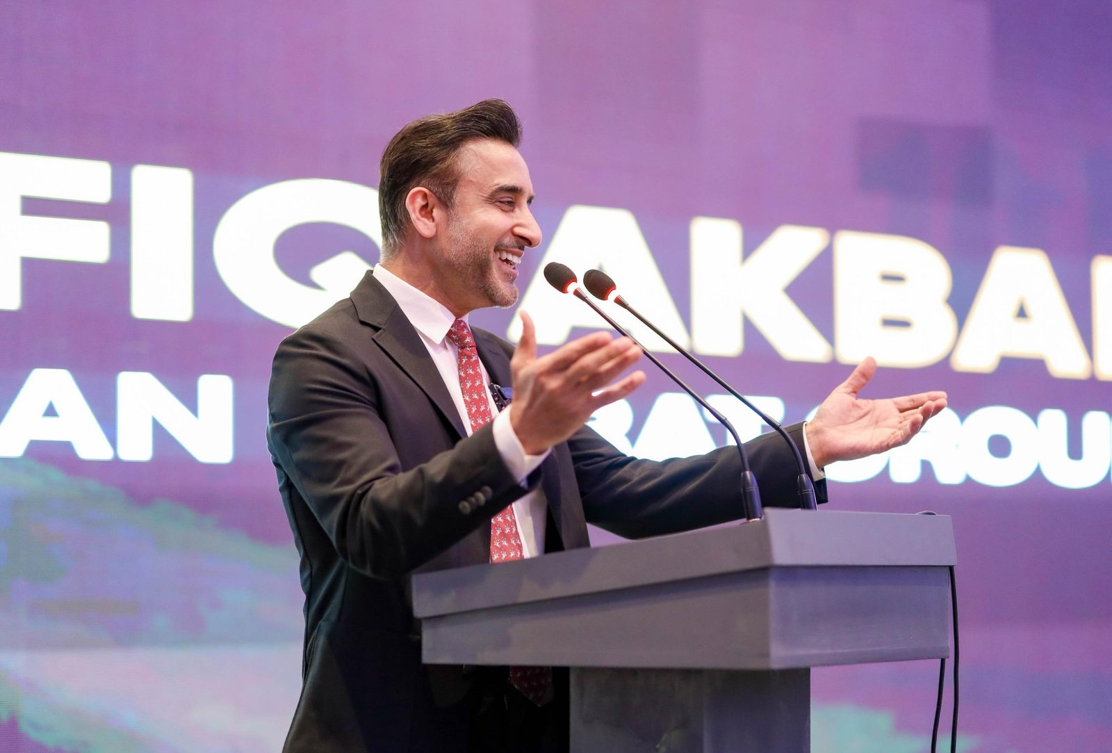 British-Pakistani businessman Shafiq Akbar announces an online property verification service for overseas Pakistanis at an investment event in Manchester.