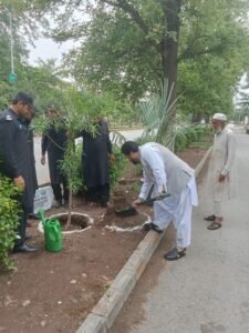 Secretary Junaid Khan plants a sapling during the launch of the Peshawar Urban Monsoon Tree Plantation Campaign 2026.